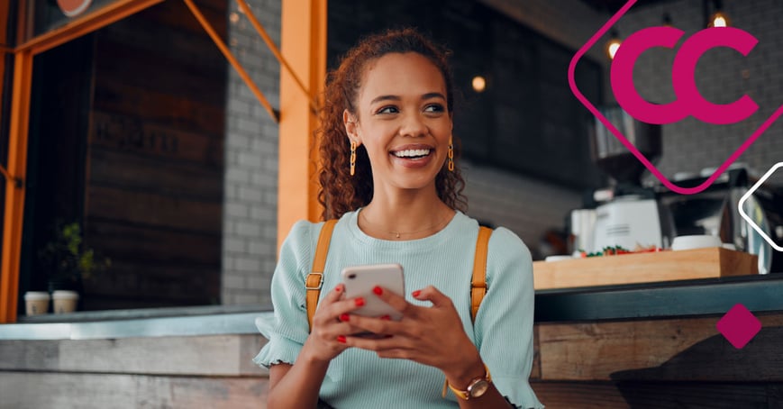 Women typing on cell phone smiling