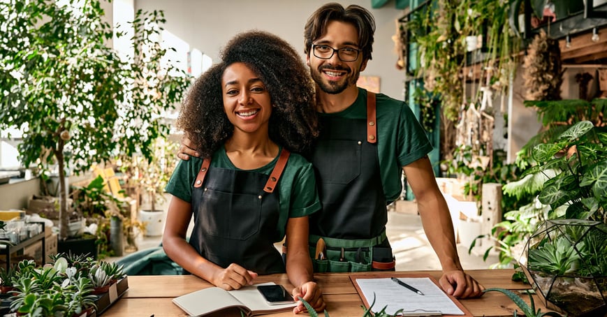 Business owner couple standing in their shop 