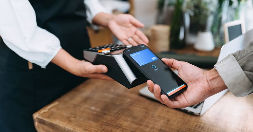 Phone of customer using Apple Pay checking out 