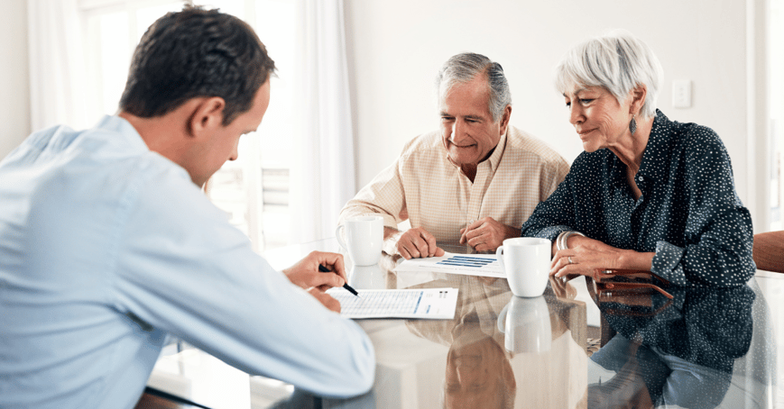 Couple viewing retirement plans at table