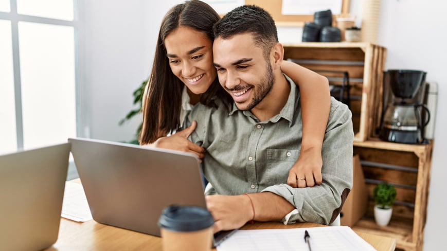 Millenial couple planning finances together at laptop