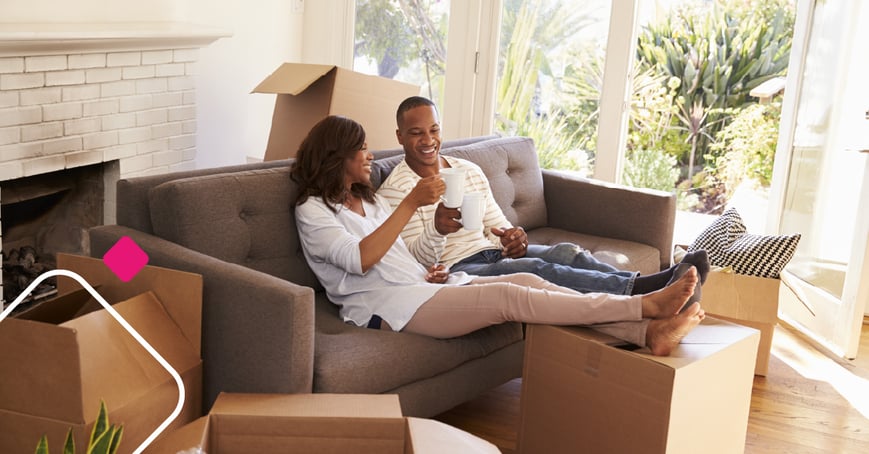 Couple sitting on couch of new home