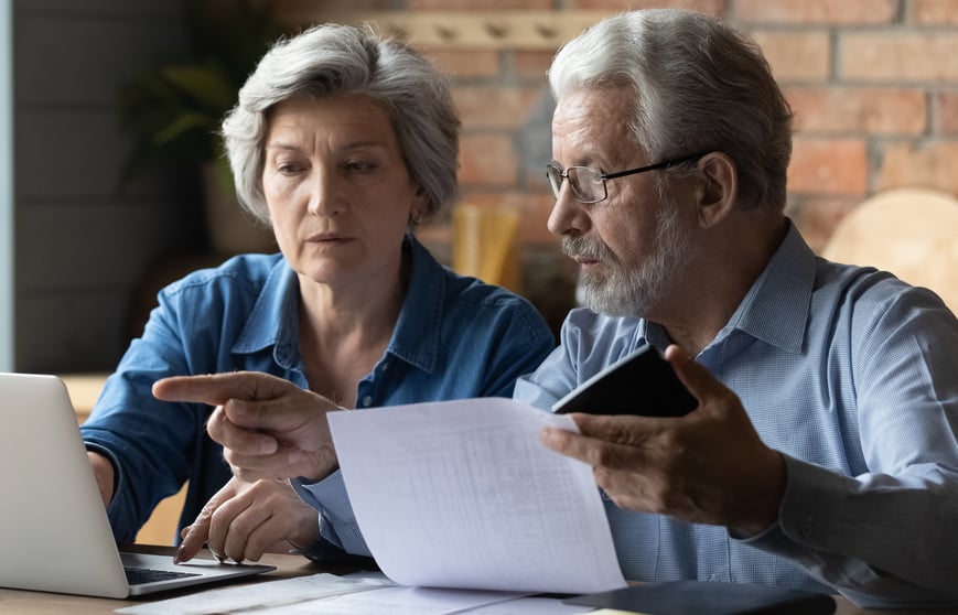 Older couple calculating retirement planning and finances