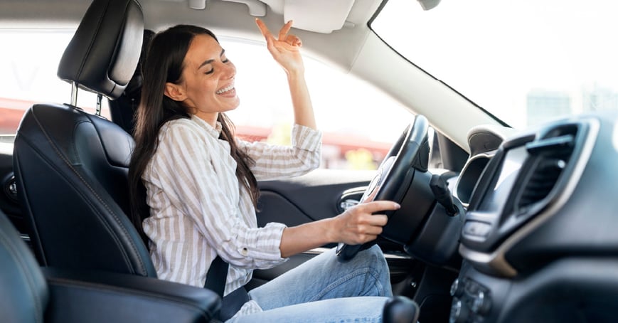 Woman driving in new car